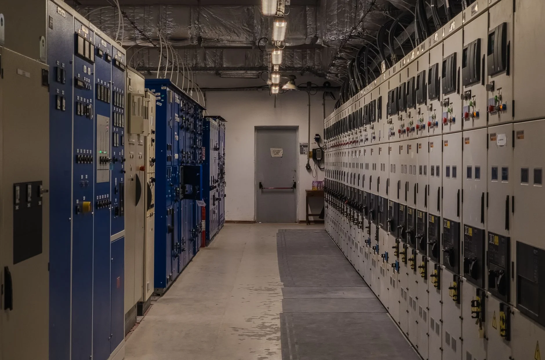 Industrial control room lined with electrical panels, representing the engineered context behind a supplier bid evaluation