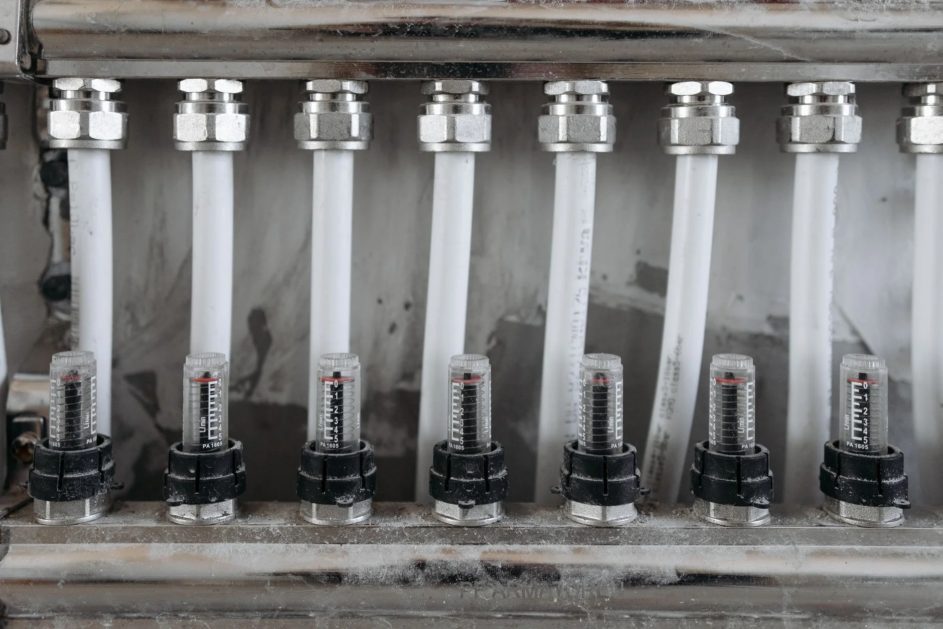 A manifold of instrumented industrial flow meters and valves in a metal framework, the kind of engineered scope that supplier bids are written against