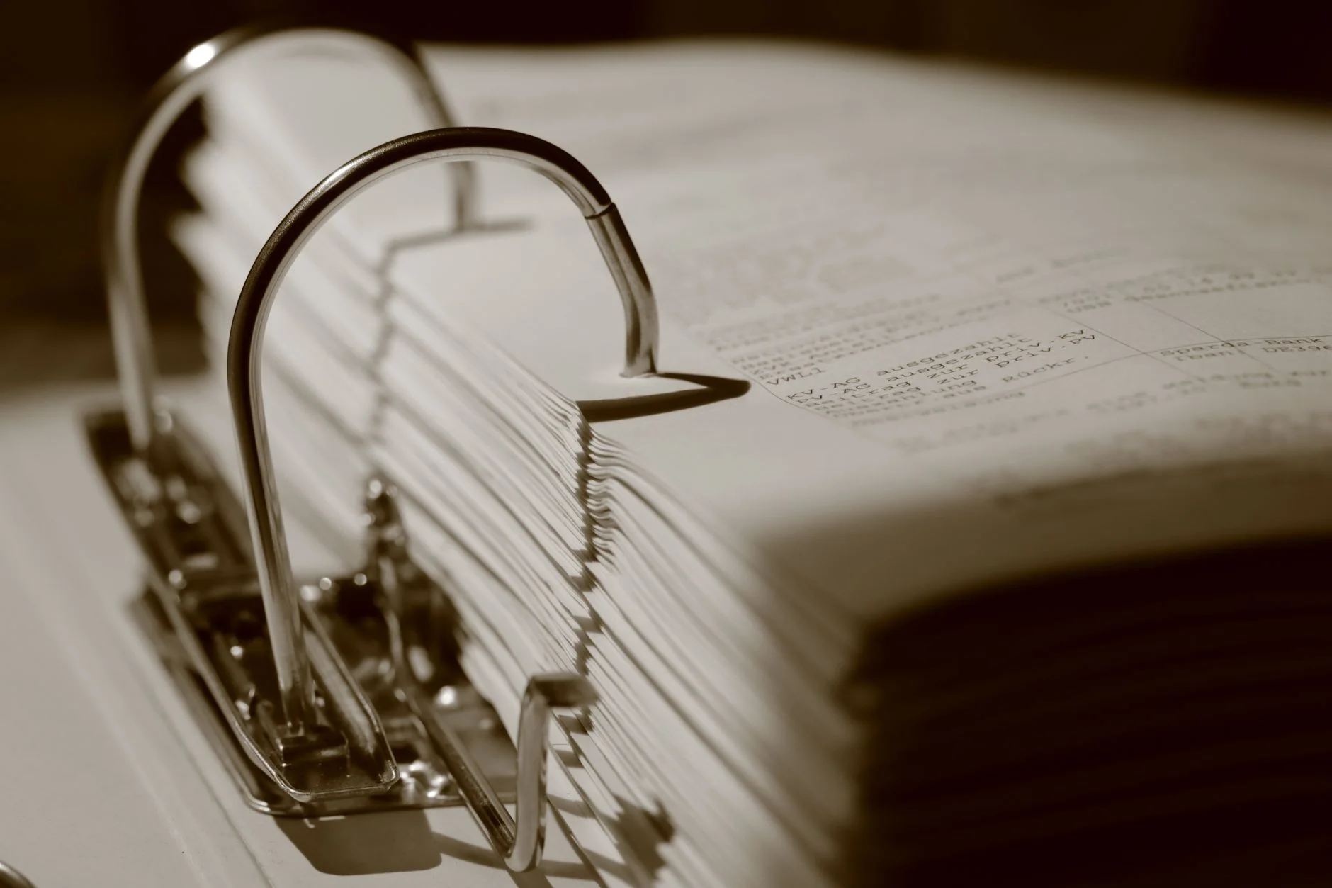 Close-up of a thick binder filled with documents, representing the policy and control evidence behind each security questionnaire answer